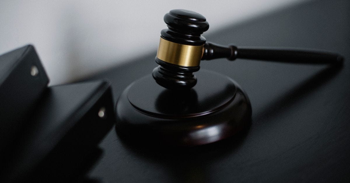 Photo: Sora Shimazaki / Pexels High angle of shiny wooden ceremonial mallet with golden detail placed on judge tale near documents folders