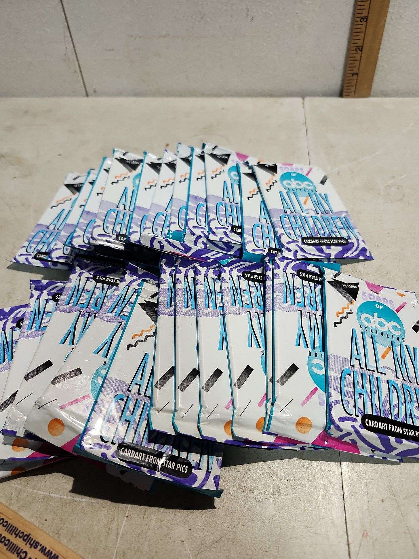 25 unopened packs of All My Children trading cards from 1991. The covers look like that Jazz logo with the blue and purple squiggles.