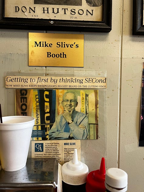 the Mike Slive table plaque, pictures of football players on a diner wall