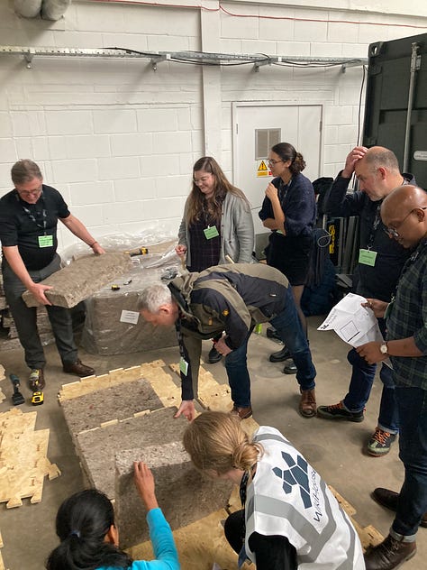 Images showing the BE-ST Fest conference attendees and a series of images of a WikiHouse build. People can be seen building and insulating WikiHouse blocks and connecting them together.