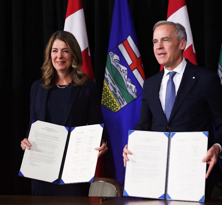 Carney and Smith hold up their copies of the latest Alberta-Canada agreement