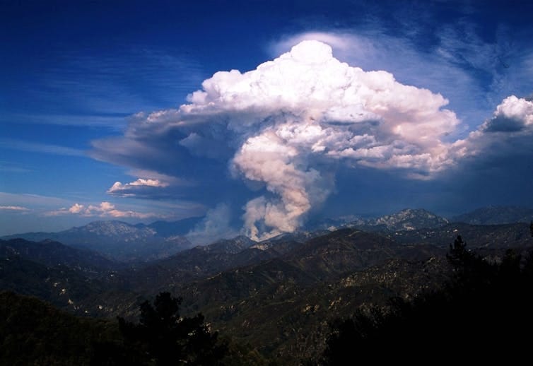 A large cloud looking like a thunderstorm rise above a canyon. A large cloud looking like a thunderstorm rise above a canyon.