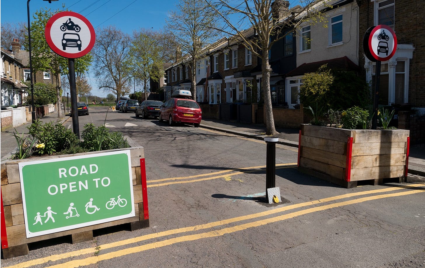 An example of a A low traffic neighbourhood with traffic bollards and signage supporting cycle through routes