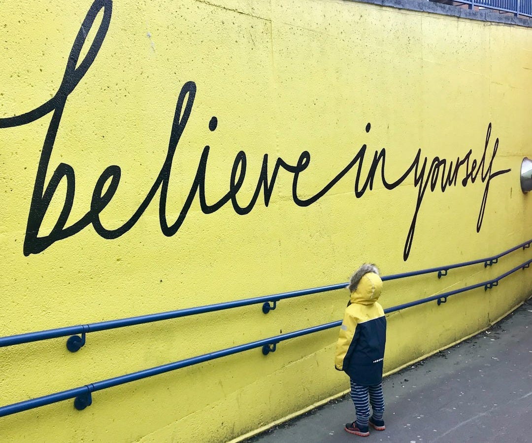 toddler looking at believe in yourself graffiti toddler looking at believe in yourself graffiti