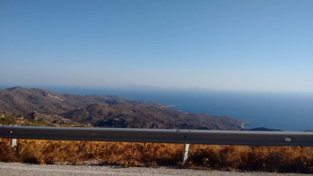 From the roadside in Ios, Santorini can be seen in the distance.