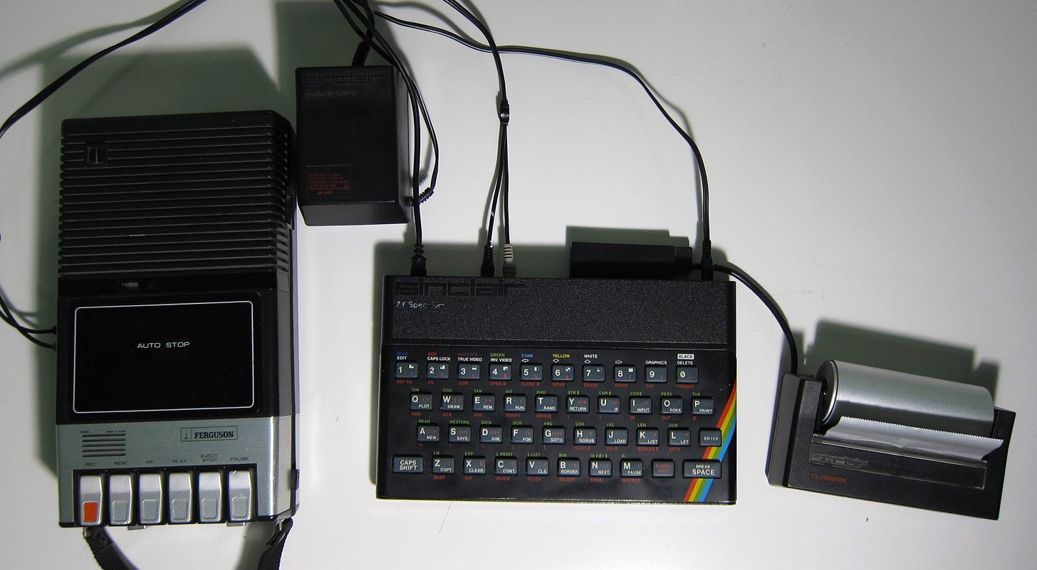 Sinclair ZX Spectrum 48K computer, Ferguson cassette tape recorder, Sinclair power supply, and Sinclair ZX Printer. All items are connected together. 