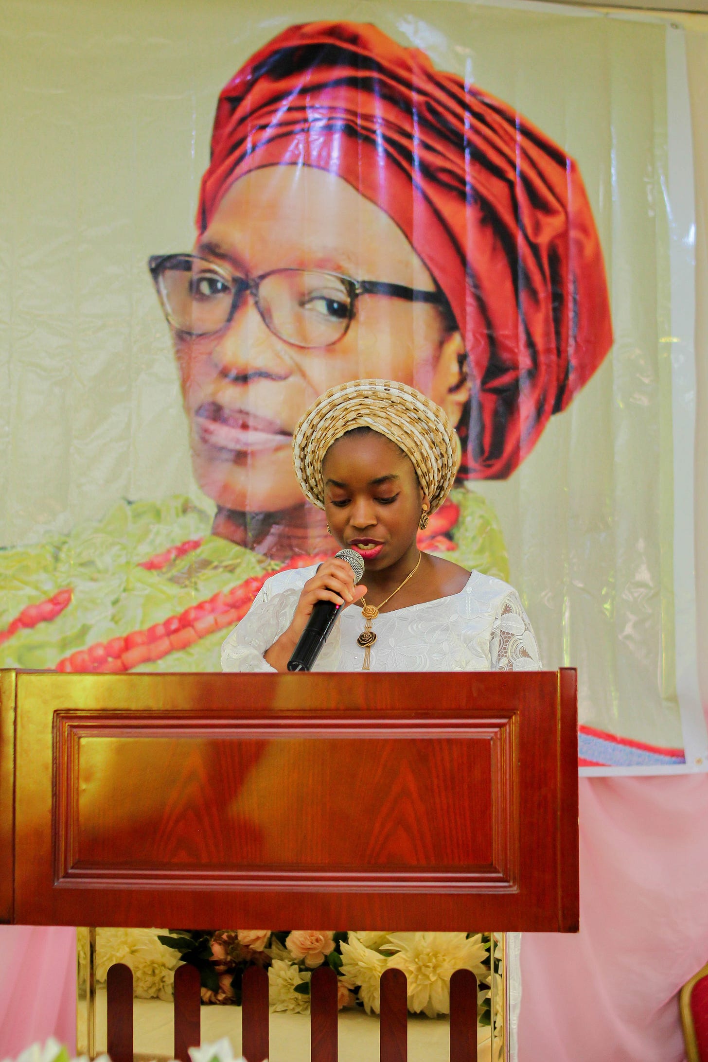 Potrait of Motunrayo reading at an event