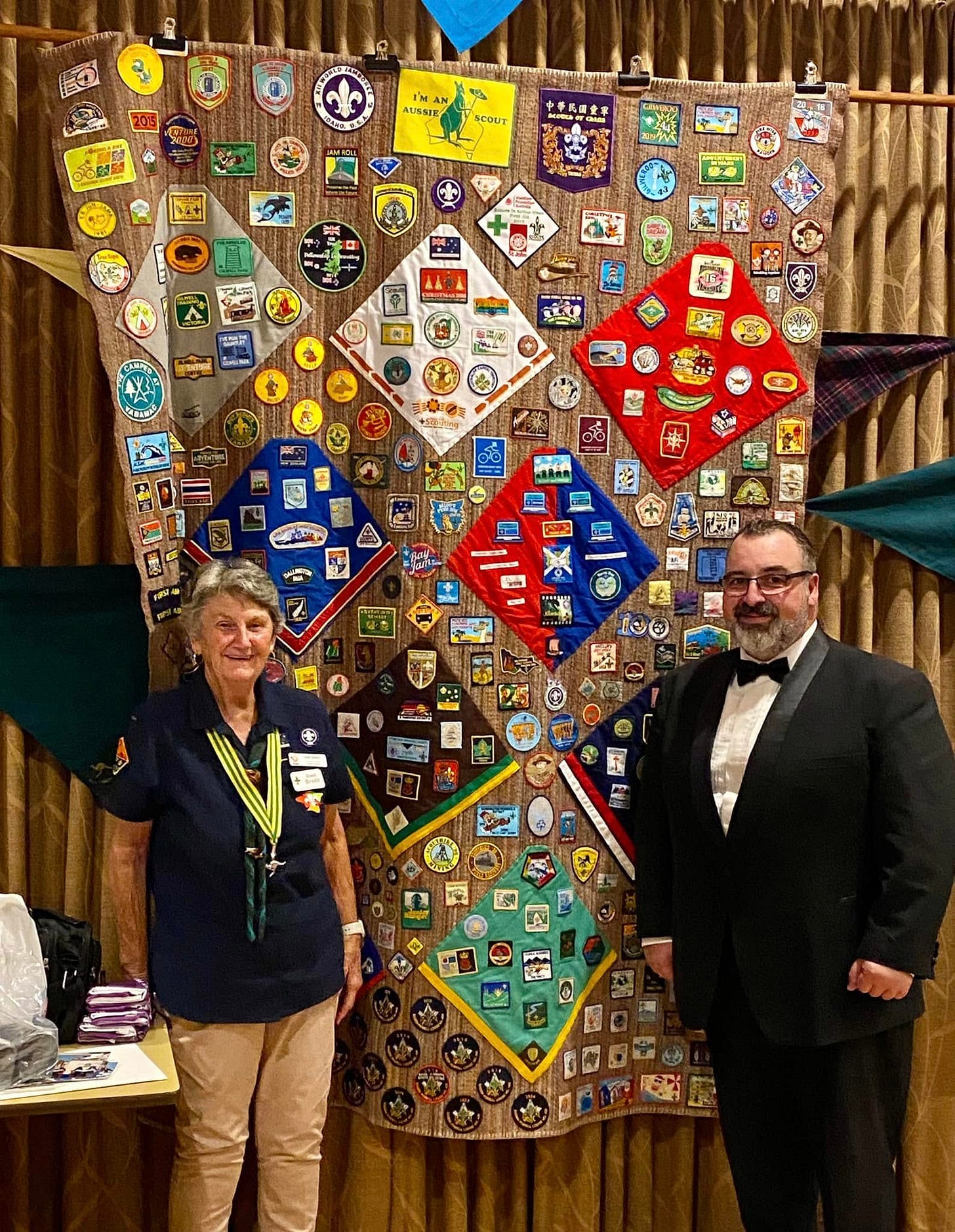 May be an image of 2 people, quilt and text