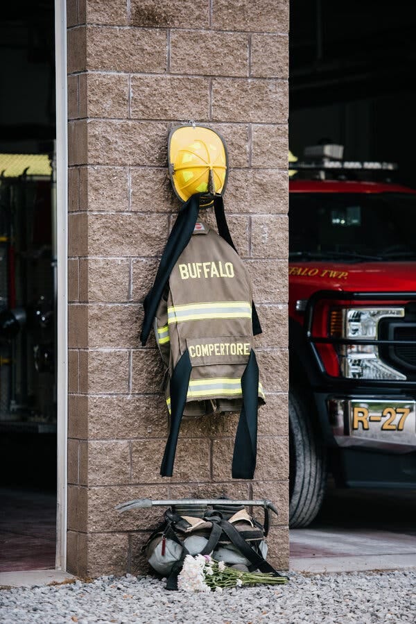 On the wall of a fire station hangs Corey Comperatore’s fire uniform and helmet. On the wall of a fire station hangs Corey Comperatore’s fire uniform and helmet.