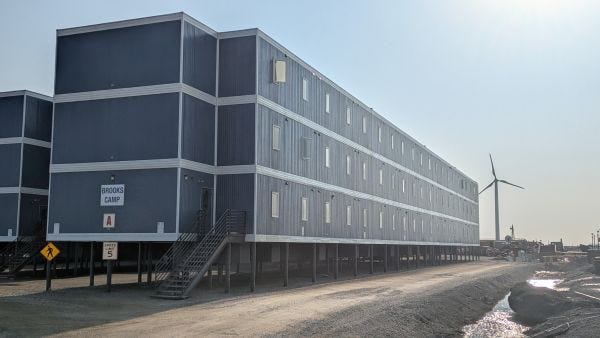 a three story building labelled Brooks Camp, built on stilts