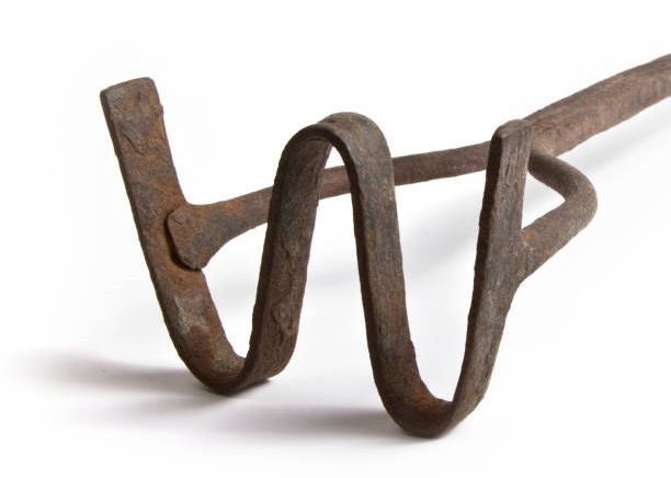 photo of an iron rod with a giant "W" on the end used for branding livestock