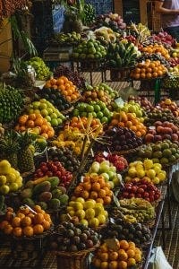 a farmer's market with colorful foods in baskets.