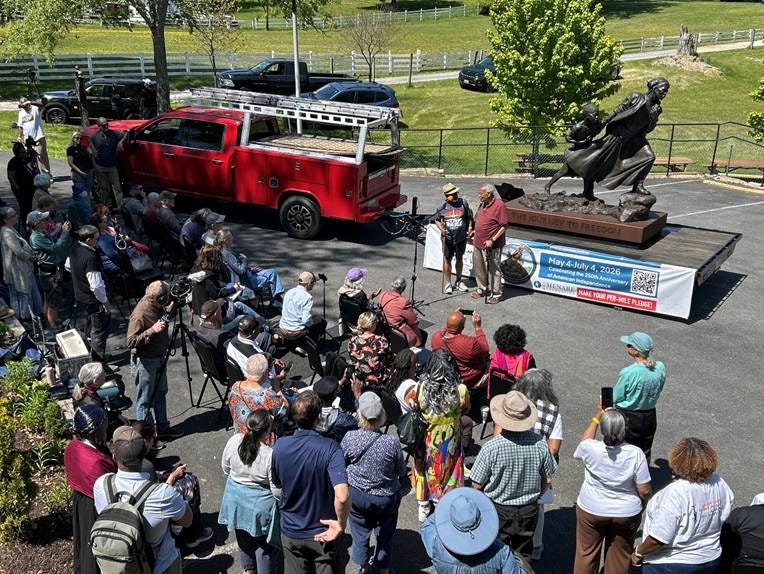 The image depicts a red truck parked at a Freedom Walk event, with a statue, people gathered, and a banner indicating a celebration for the 250th Anniversary of American Independence.
AI-generated content may be incorrect. The image depicts a red truck parked at a Freedom Walk event, with a statue, people gathered, and a banner indicating a celebration for the 250th Anniversary of American Independence.
AI-generated content may be incorrect.