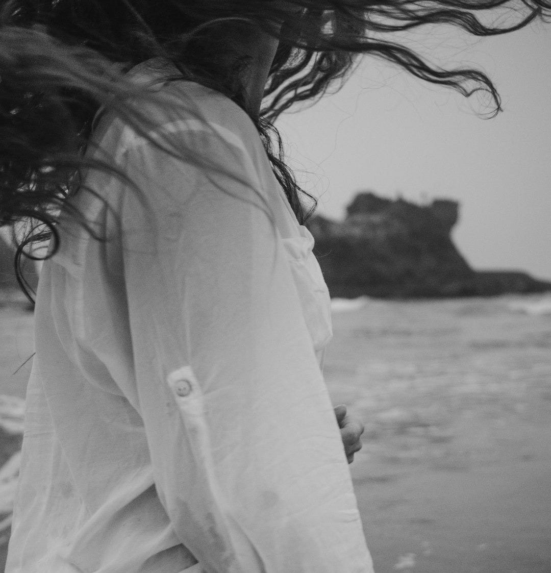 Woman walking in the ocean waves Woman walking in the ocean waves