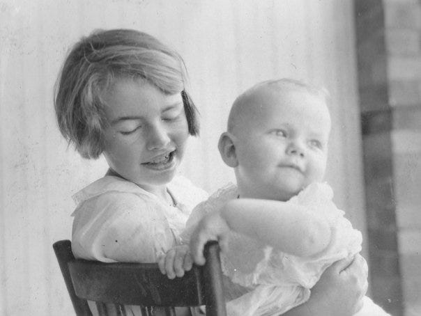 A young Jean Allan holding her wee brother, Sandy