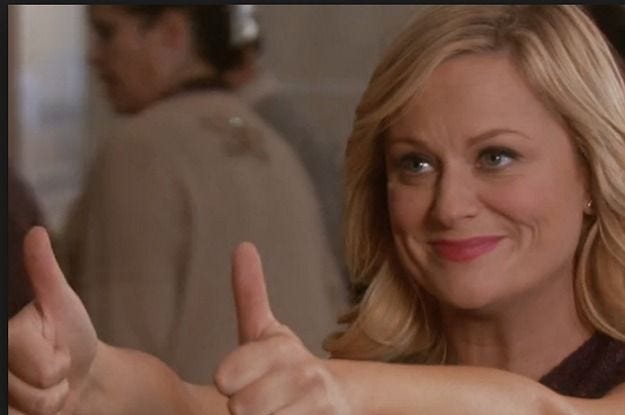 This may contain: a woman giving the thumbs up sign