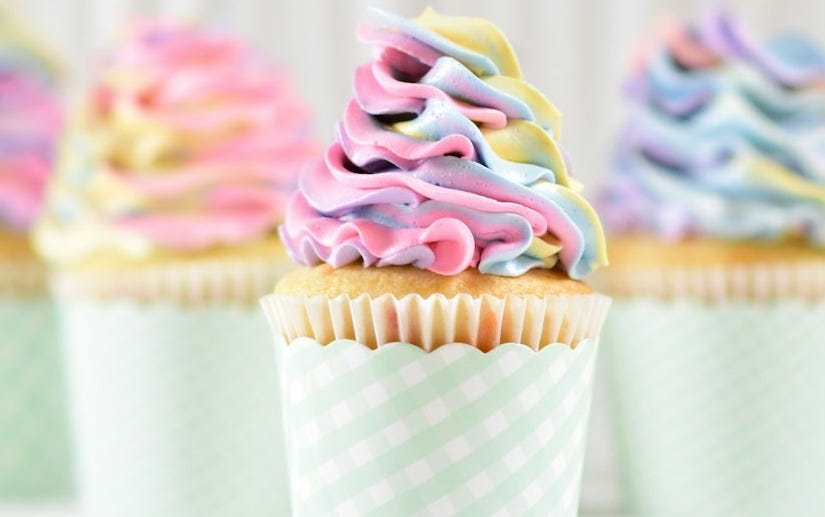 frosting on two cupcakes frosting on two cupcakes