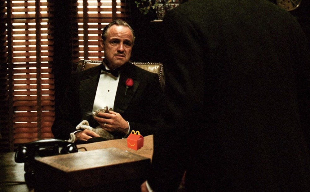 Image from The Godfather with a tiny superimposed Happy Meal toy on Marlon Brando's desk