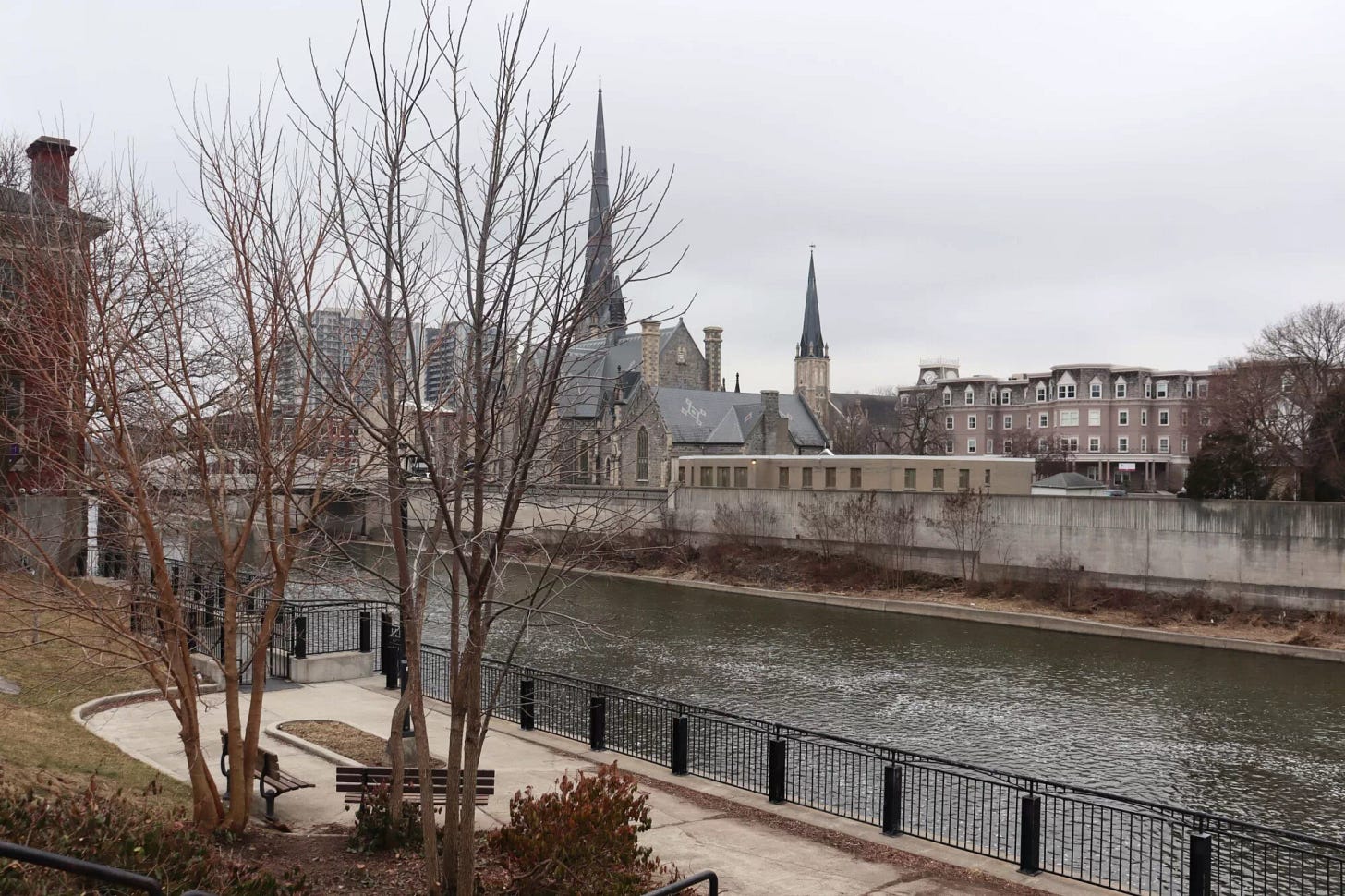 Cambridge landscape, with a tall church tower in the distance and the river flowing in the foreground. Cambridge landscape, with a tall church tower in the distance and the river flowing in the foreground.