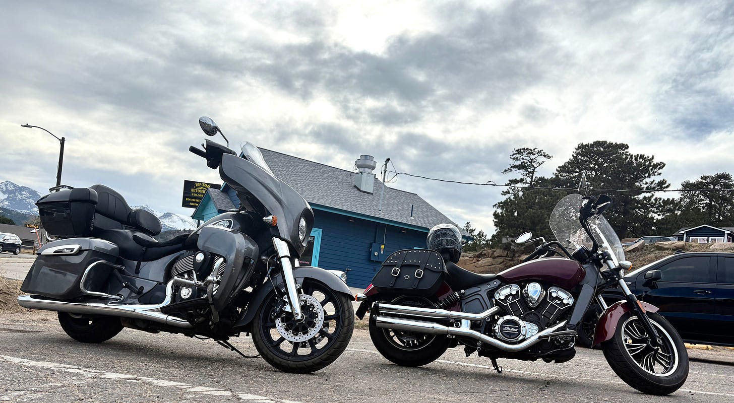 two motorcycles parked in a lot