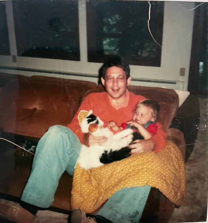 Man holding a white calico cat, baby bottle, and baby; Elderly man holding a cat