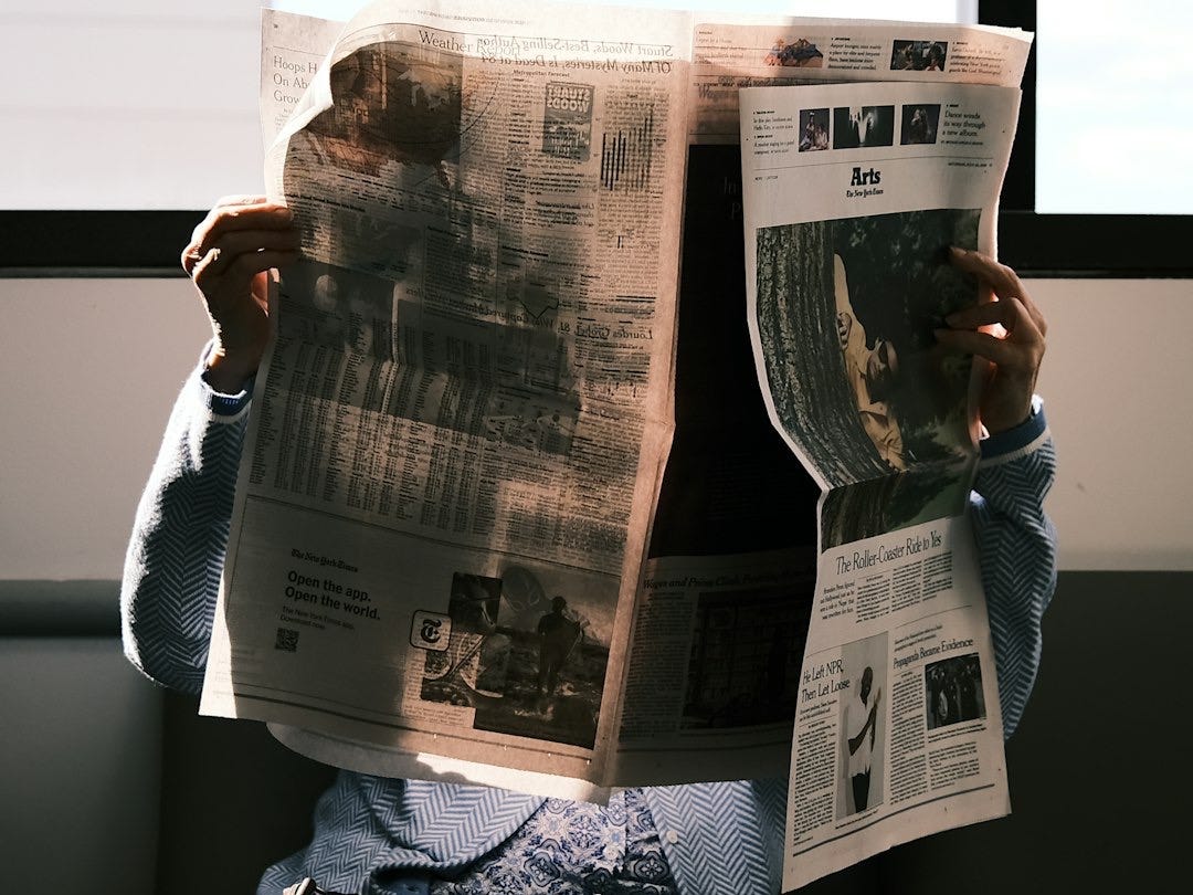 a person reading a newspaper a person reading a newspaper