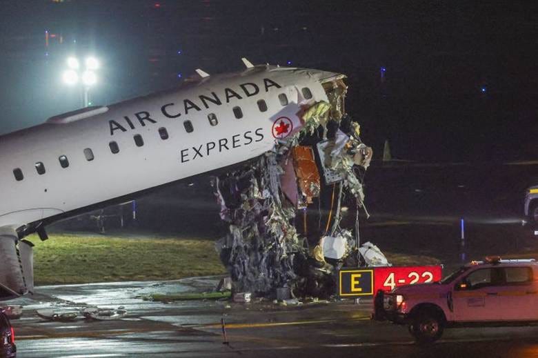 An Air Canada Express CRJ-900 sits on the runway after colliding with a Port Authority fire truck at LaGuardia airport, New York An Air Canada Express CRJ-900 sits on the runway after colliding with a Port Authority fire truck at LaGuardia airport, New York