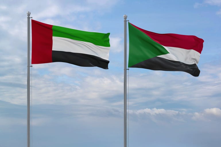سودان الإمارات Sudan and United Arab Emirates, UAE flags waving together in the wind on blue cloudy sky, two country relationship concept