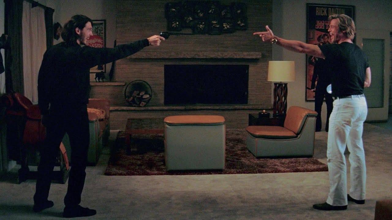 Tex Watson pointing a gun at Cliff Booth. Tex Watson pointing a gun at Cliff Booth.