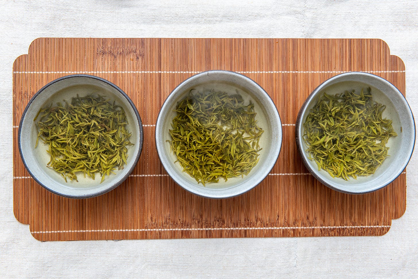 ID: Lineup of three bowl brewed green teas