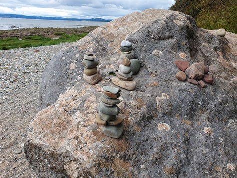 9 pictures of one large rock, each picture has different configurations of small rocks piled on top of it