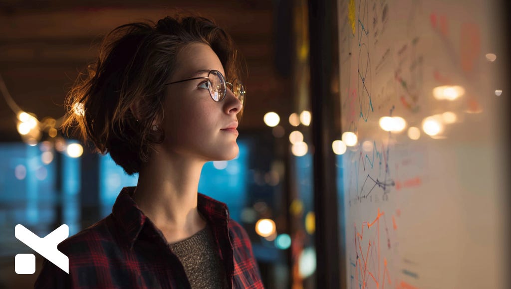 a woman looking at a white board in a conference room