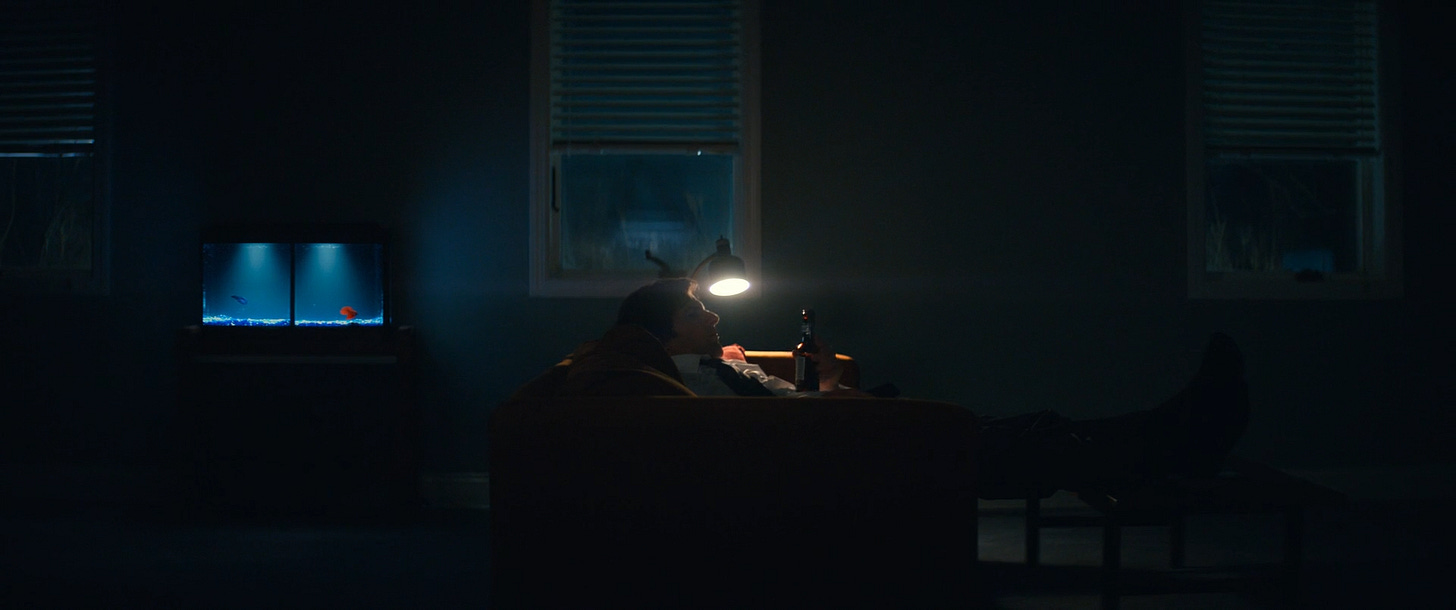 Mark with a bottle of beer on his couch