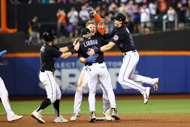 New York Mets' Pete Alonso, center right, celebrates with Francisco Lindor (12), Brett Baty, and Jeff McNeil after hitting a walkoff-single to win against the Colorado Rockies during the bottom of the ninth inning of a baseball game on Friday, Aug. 26, 2022, in New York. New York Mets' Pete Alonso, center right, celebrates with Francisco Lindor (12), Brett Baty, and Jeff McNeil after hitting a walkoff-single to win against the Colorado Rockies during the bottom of the ninth inning of a baseball game on Friday, Aug. 26, 2022, in New York.
