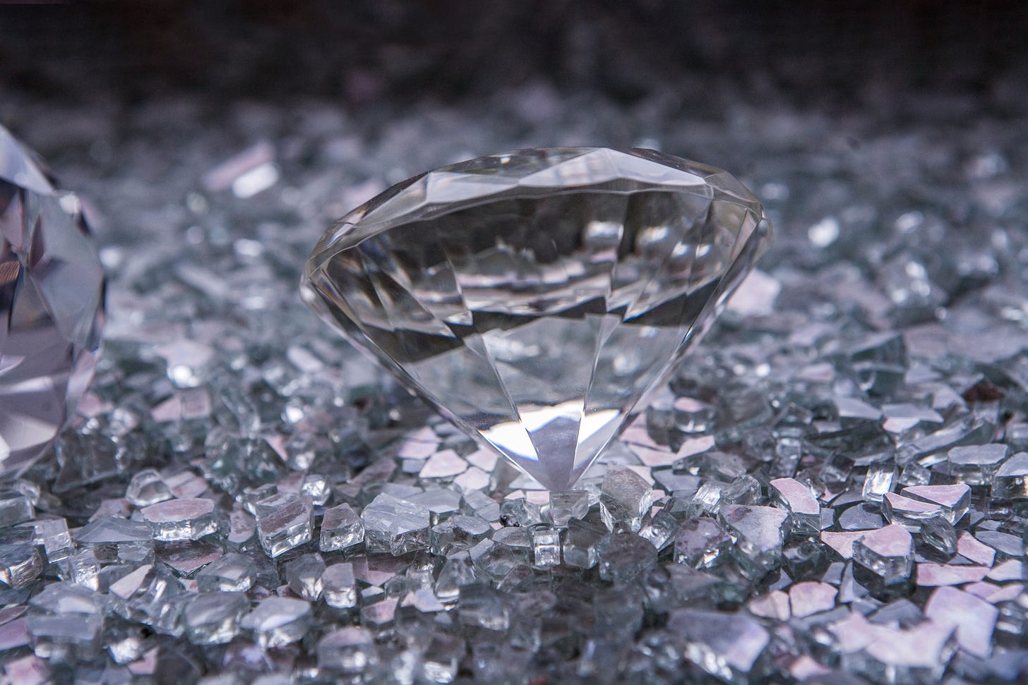 A large diamond resting on white shards of glass A large diamond resting on white shards of glass