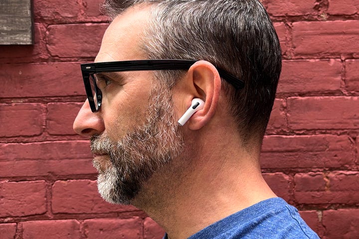 Two photos of the author seen from the side wearing Apple AirPods Pro 3 and Baseus Inspire XC1.