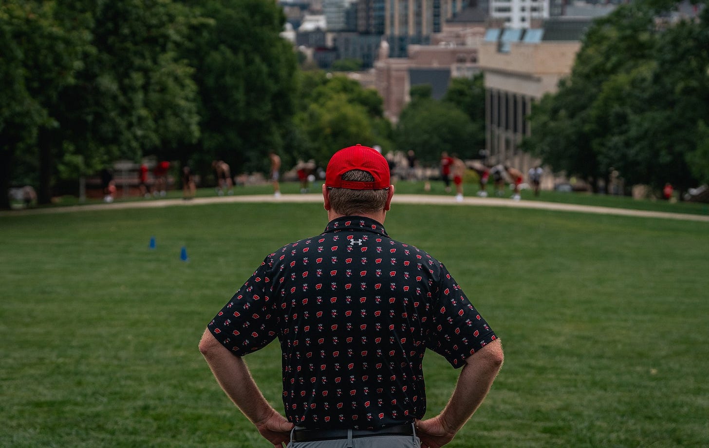 Wisconsin Badgers head coach Greg Gard watches his team complete its annual run up Bascom Hill. Wisconsin Badgers head coach Greg Gard watches his team complete its annual run up Bascom Hill.