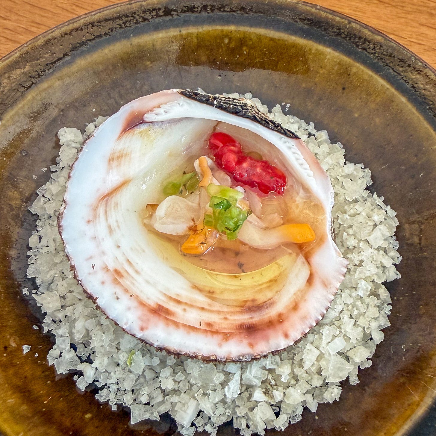 Cockles with rose vinegar, verbena and raspberry served in a shell on salt at Bittikesu, Paris 4th Cockles with rose vinegar, verbena and raspberry served in a shell on salt at Bittikesu, Paris 4th