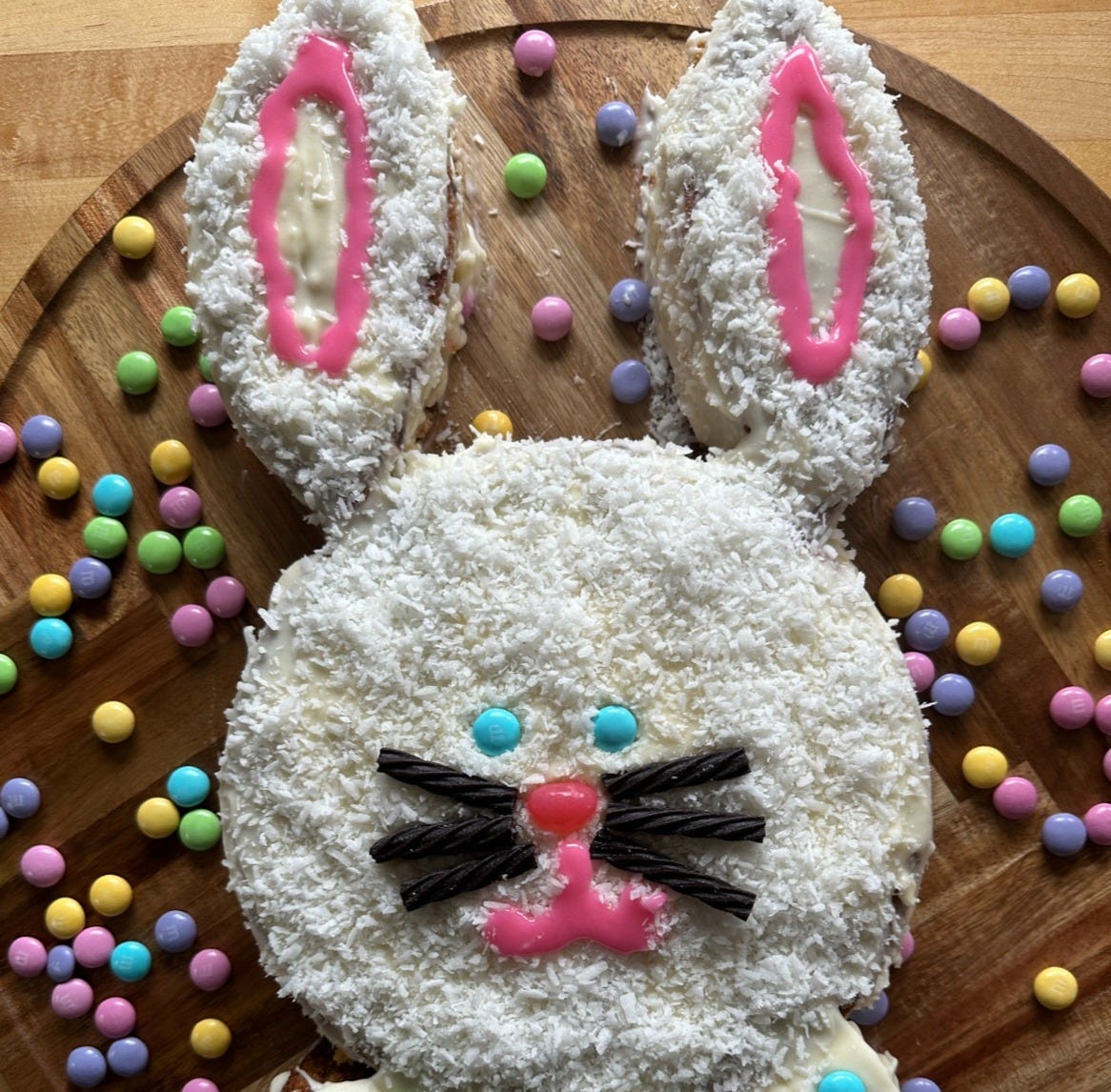 A cake that looks like a bunny surrounded by M&Ms.