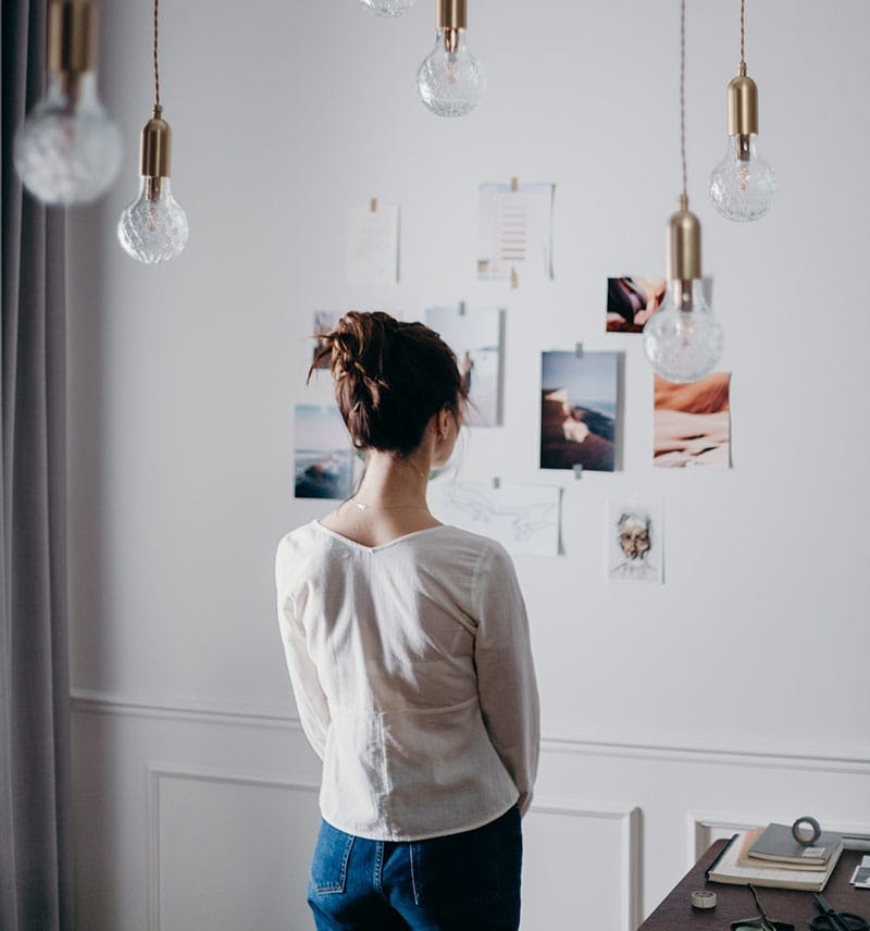 woman looking at images - getting inspired for vision board