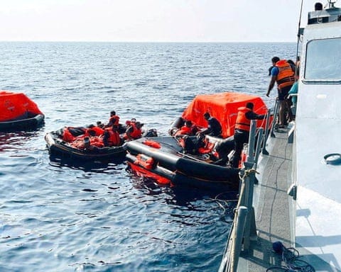 People on life rafts in the Indian Ocean are brought on to another ship People on life rafts in the Indian Ocean are brought on to another ship