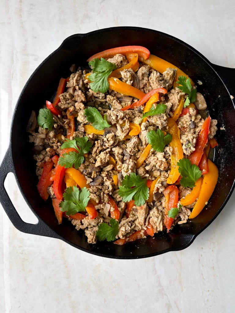Green salsa taco skillet with peppers, turkey, and fresh cilantro