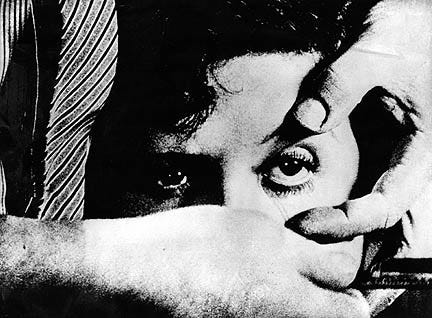 The most frequently seen still from Buñuel’s Un chien Andalou (1929). A close-up of a woman's face. One eye is held open by a man's hand while, in the other he holds an open razor.