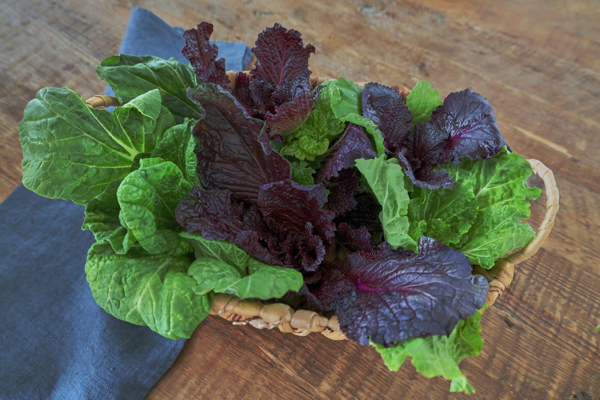 mustard greens in a basket with a napkin mustard greens in a basket with a napkin