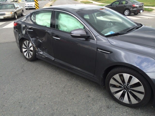 My car after another driver enters intersection 10 secs after light turns red.