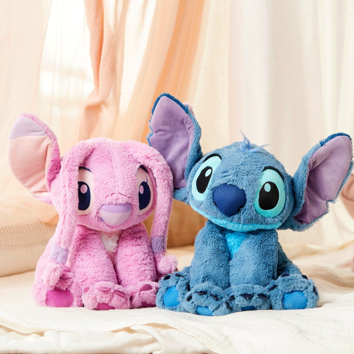 The medium Angel and Stitch plush, $12 each with any Disney Store purchase on Toy Tuesday. Image: Disney Store