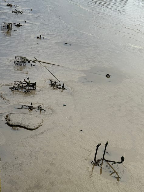 Machinery and industrial detritus emerging from sludge