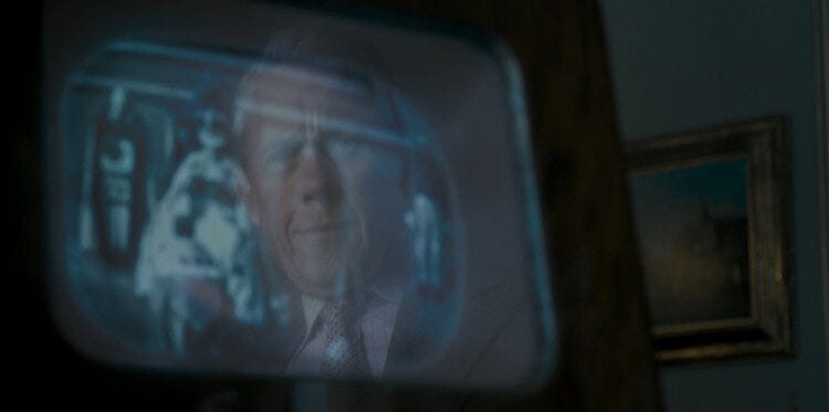Almost King, now gazing at his niece, now his Queen, through a TV screen.