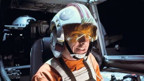 Luke Skywalker smiling while piloting an X-Wing in Star Wars A New Hope Luke Skywalker smiling while piloting an X-Wing in Star Wars A New Hope