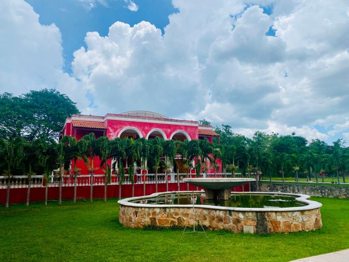 Red Hacienda outside of Merida Yucatan with fountain and gardens Red Hacienda outside of Merida Yucatan with fountain and gardens